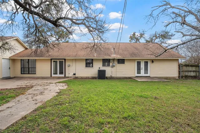 a view of a yard with a house and a large tree