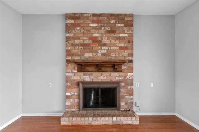 a living room with a fireplace and a wooden floor