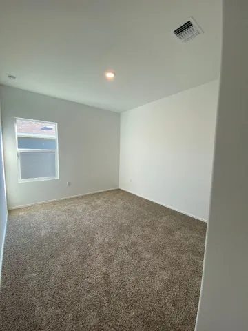 a view of an empty room and a window