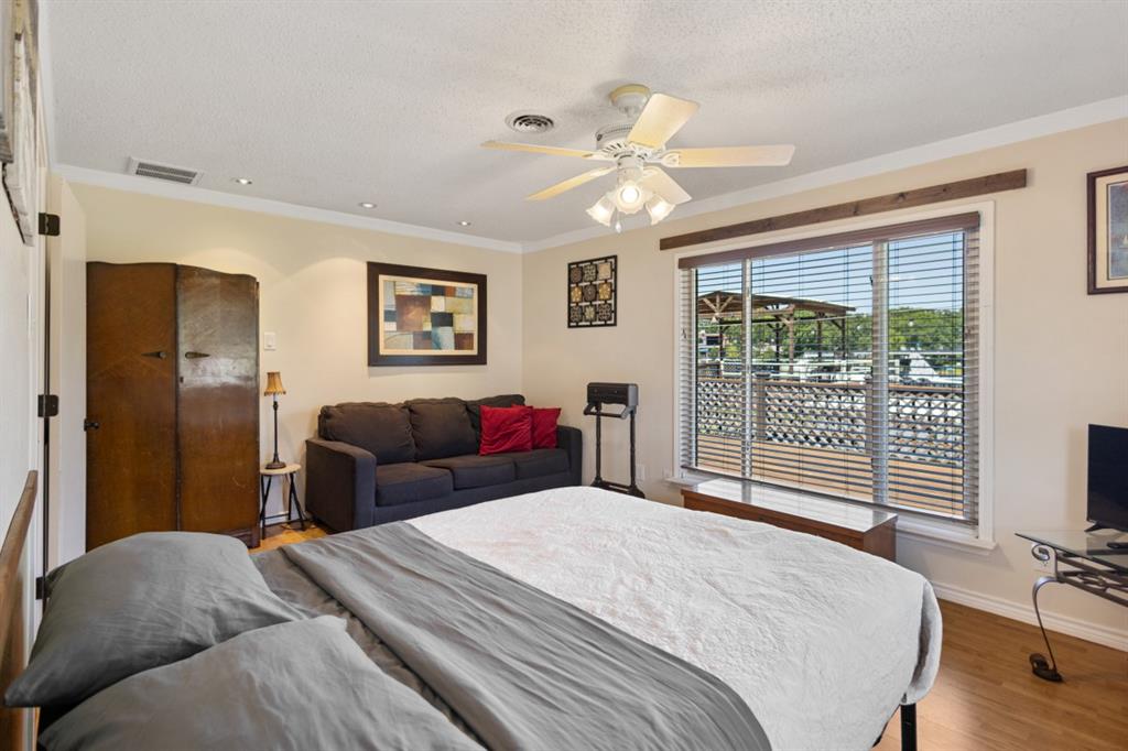 227 Scenic Road Trinidad, TX 75163 - Photo 21 of 40 a bedroom with a large bed and a large window