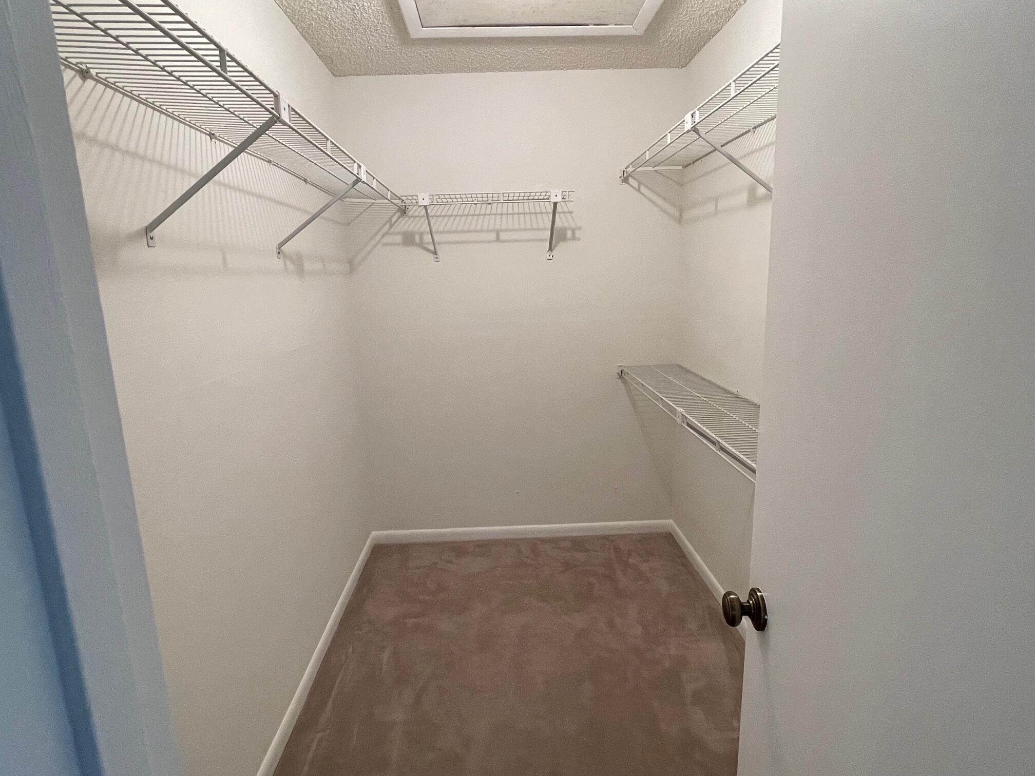 9151 Pine Springs Drive Boca Raton, FL 33428 - Photo 14 of 21 a view of a room with racks on the wall