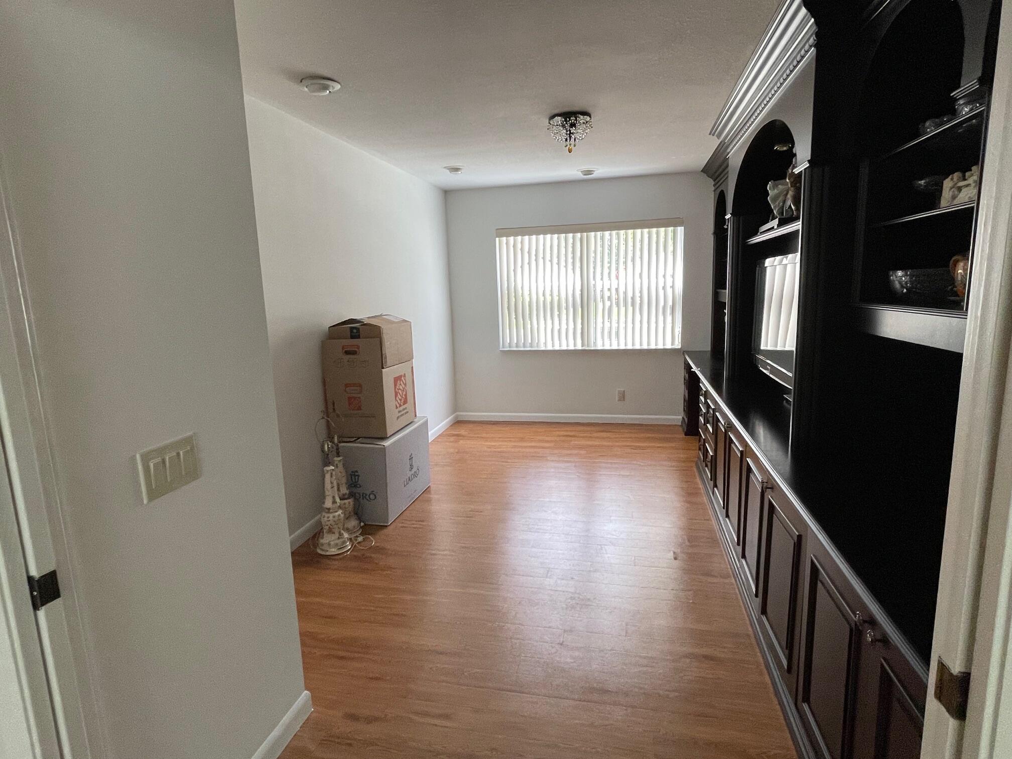 9151 Pine Springs Drive Boca Raton, FL 33428 - Photo 15 of 21 a view of hallway with stairs and wooden floor