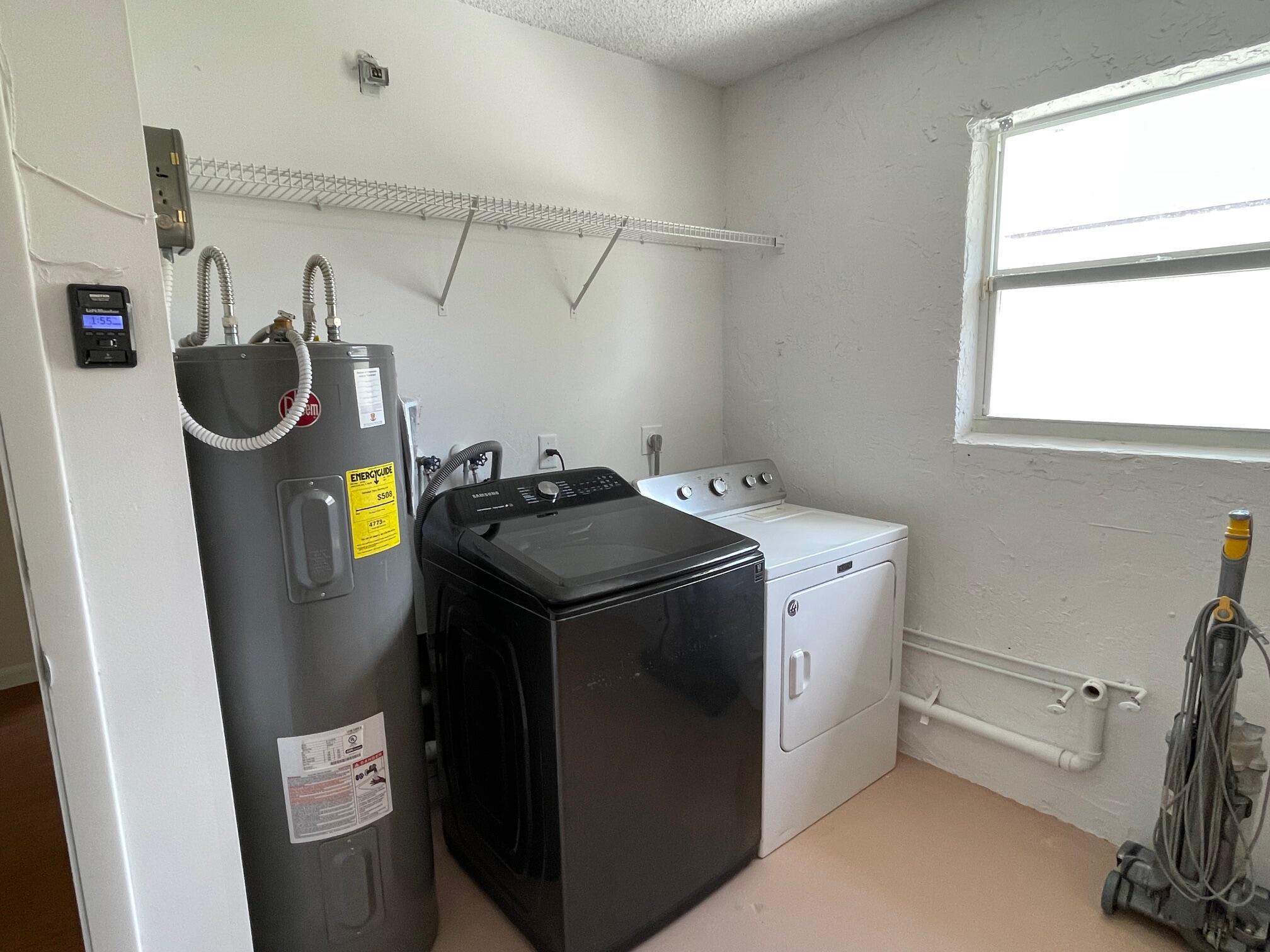 9151 Pine Springs Drive Boca Raton, FL 33428 - Photo 16 of 21 a utility room with dryer and washer
