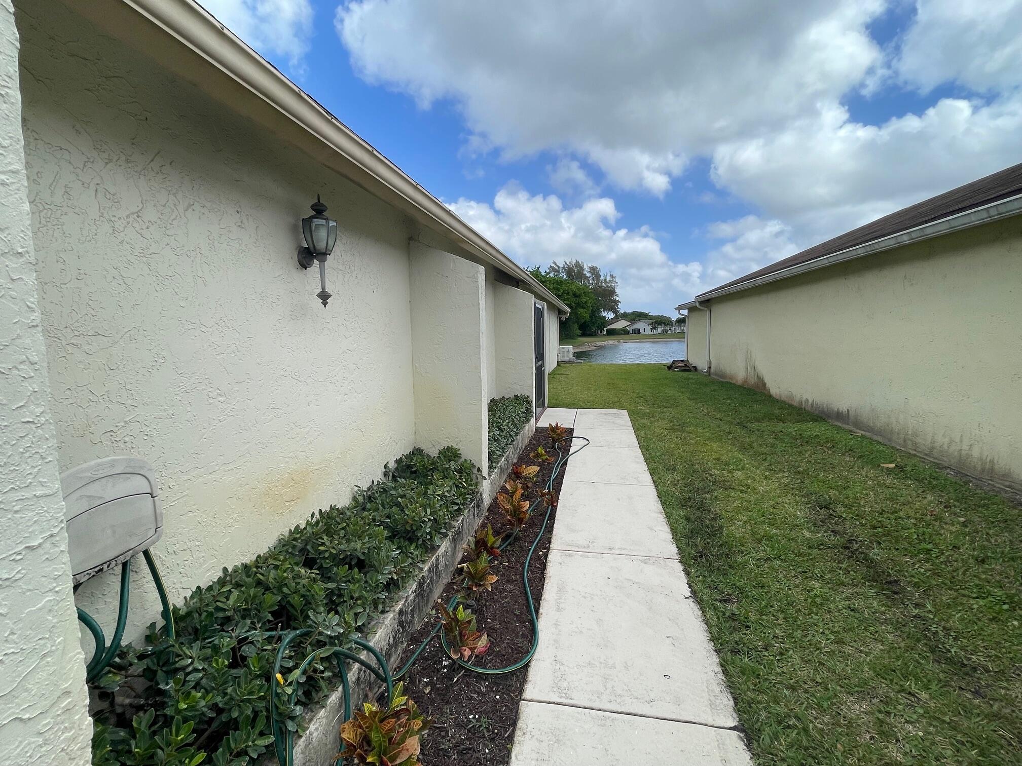 9151 Pine Springs Drive Boca Raton, FL 33428 - Photo 18 of 21 a backyard of a house with lots of green space