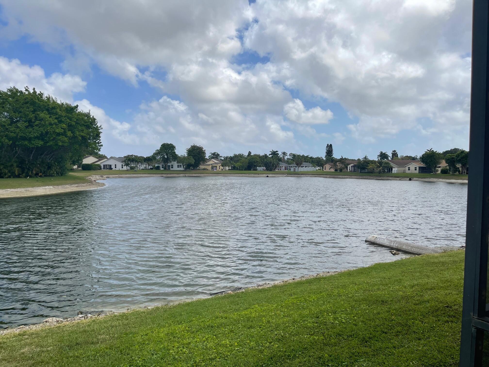 9151 Pine Springs Drive Boca Raton, FL 33428 - Photo 3 of 21 a view of a lake from a yard