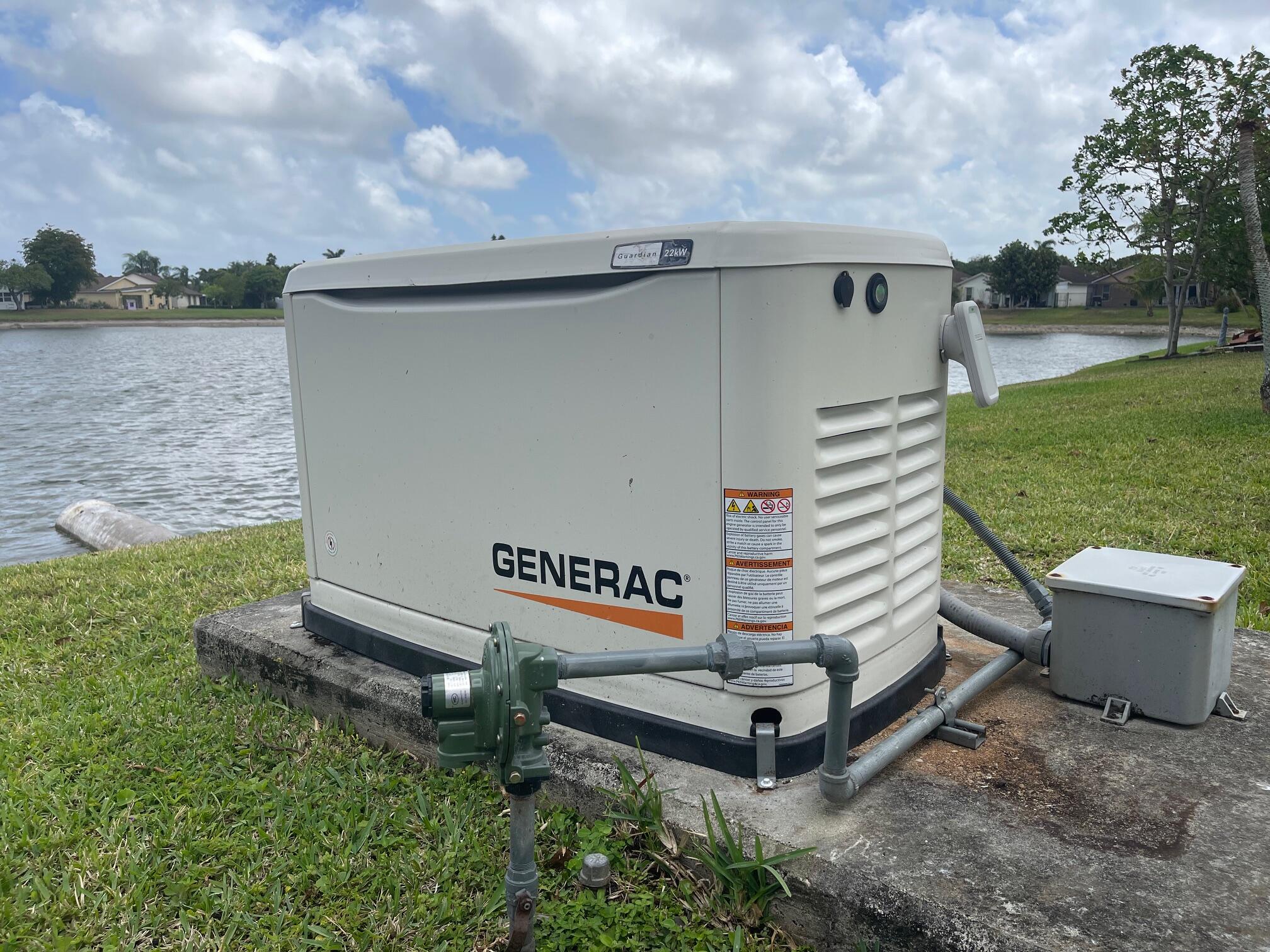 9151 Pine Springs Drive Boca Raton, FL 33428 - Photo 5 of 21 a view of a bench in the garden near a lake