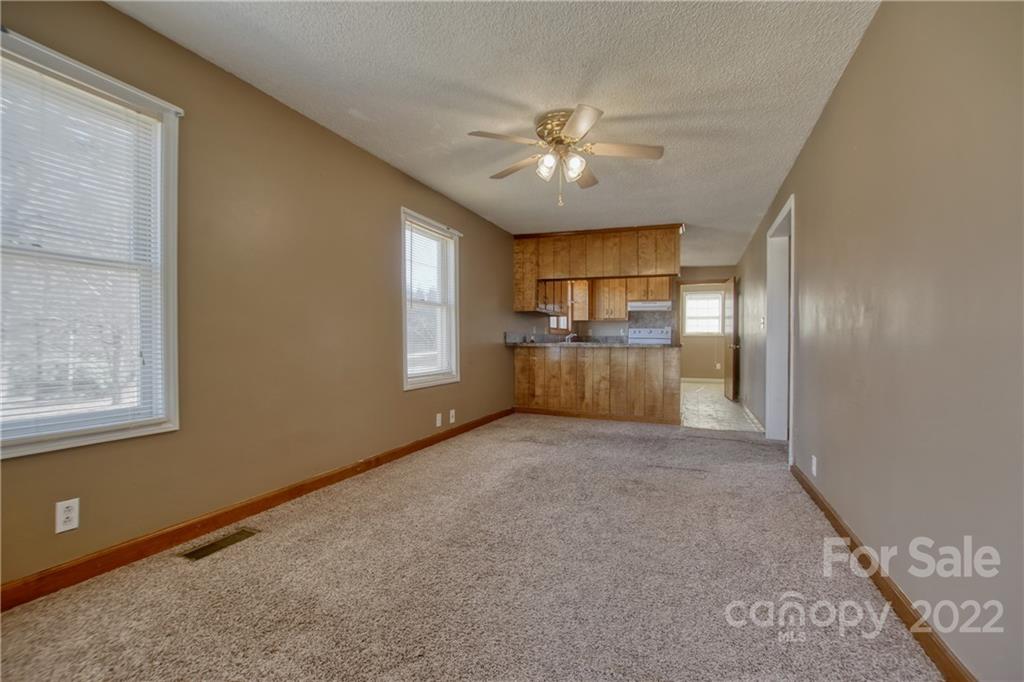 4106 Puetts Chapel Road Dallas, NC 28034 - Photo 5 of 23 an empty room with windows and chandelier fan