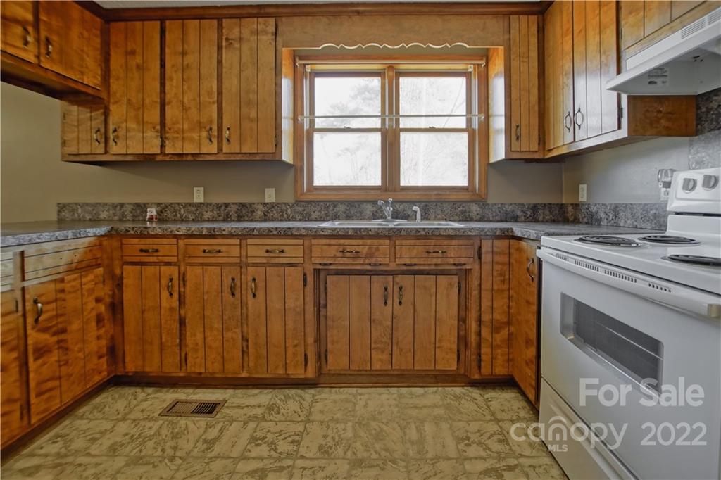 4106 Puetts Chapel Road Dallas, NC 28034 - Photo 8 of 23 a kitchen with stainless steel appliances granite countertop a stove a sink and a microwave