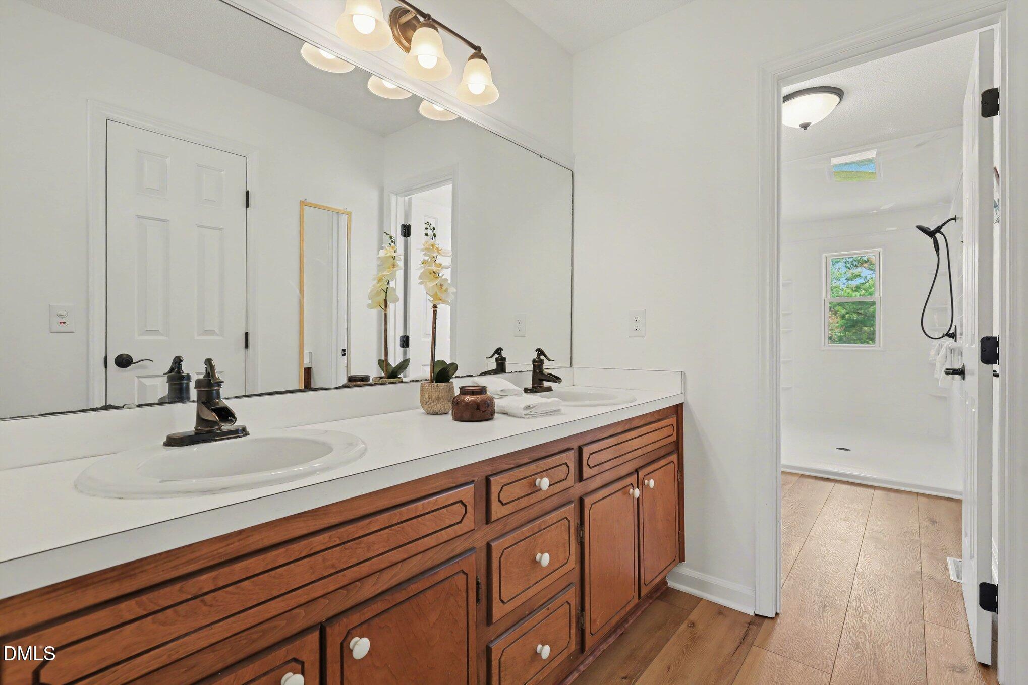 2004 Little Pond Place Willow Spring, NC 27592 - Photo 13 of 32 a bathroom with a sink and a mirror
