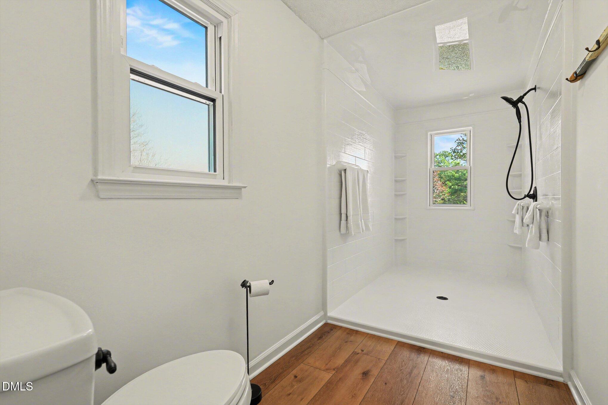2004 Little Pond Place Willow Spring, NC 27592 - Photo 14 of 32 a bathroom with a granite countertop shower a toilet and a sink