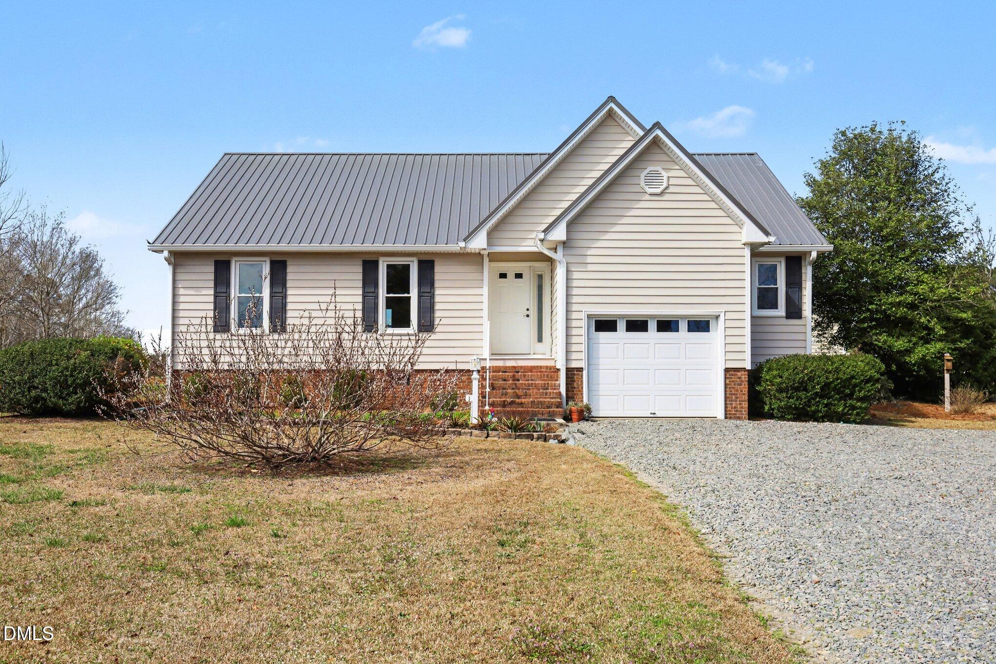 2004 Little Pond Place Willow Spring, NC 27592 - Photo 2 of 32 a front view of a house with a yard