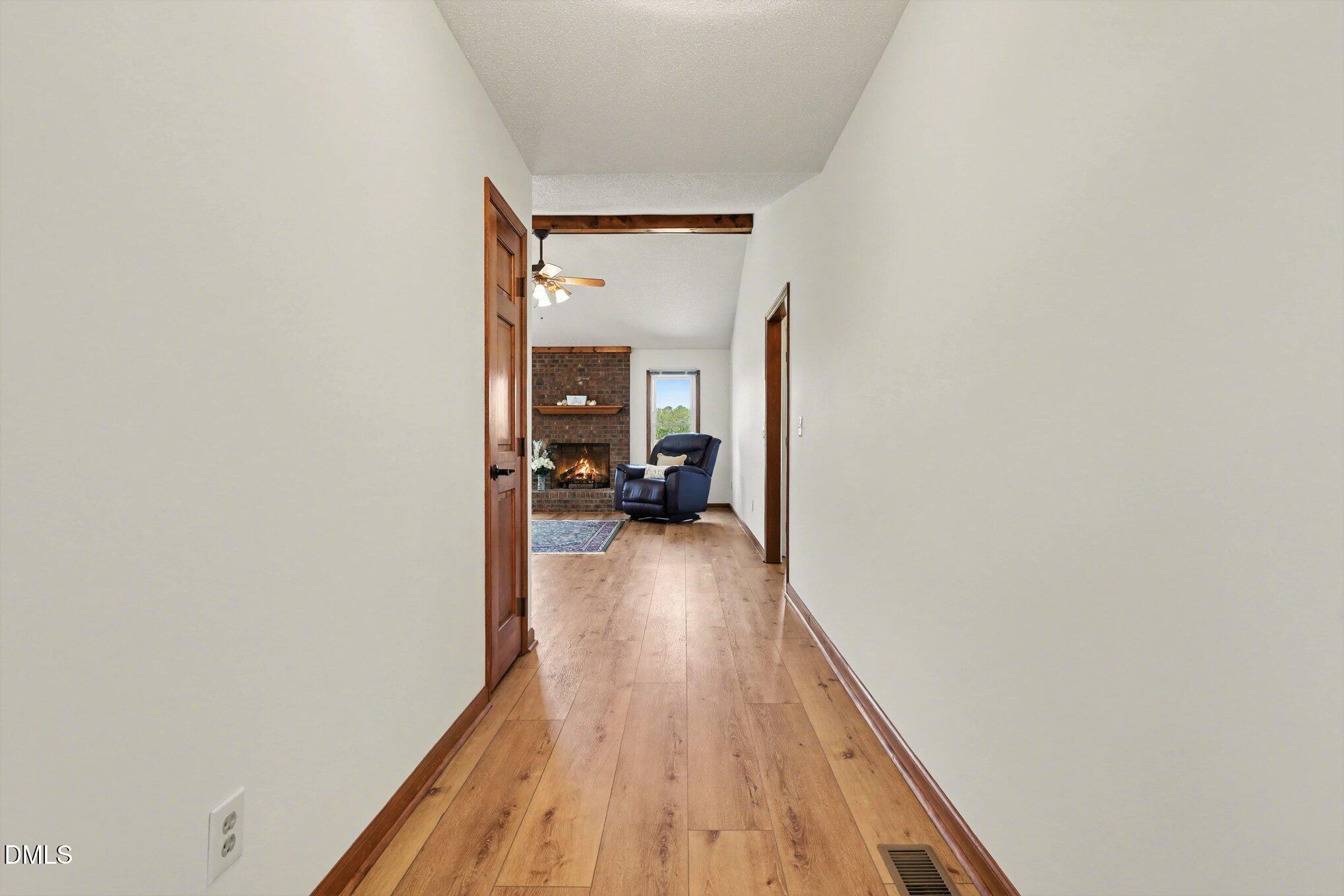 2004 Little Pond Place Willow Spring, NC 27592 - Photo 3 of 32 a view of a hallway with wooden floor and a potted plant