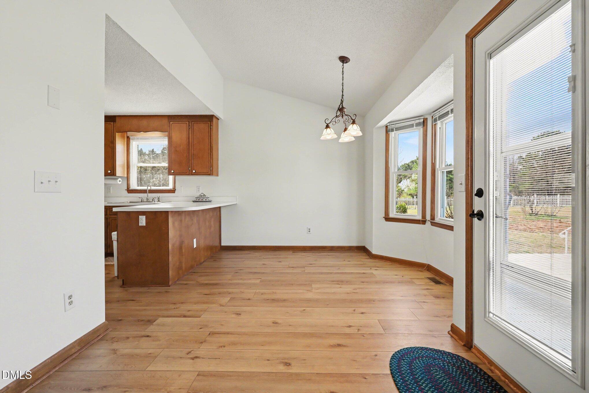 2004 Little Pond Place Willow Spring, NC 27592 - Photo 6 of 32 a view of kitchen with granite countertop cabinets and wooden floor