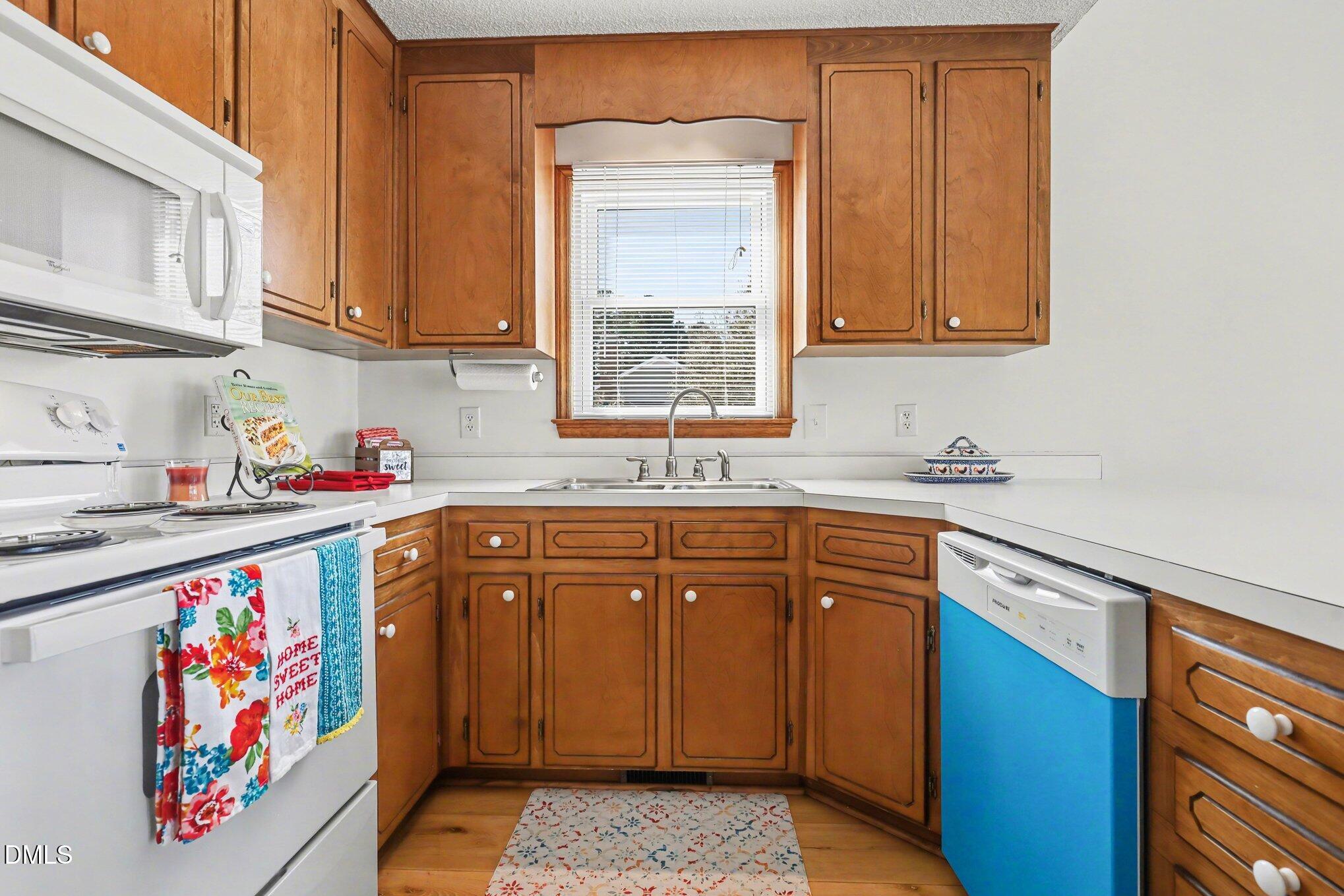 2004 Little Pond Place Willow Spring, NC 27592 - Photo 9 of 32 a kitchen with stainless steel appliances granite countertop a sink dishwasher stove and cabinets