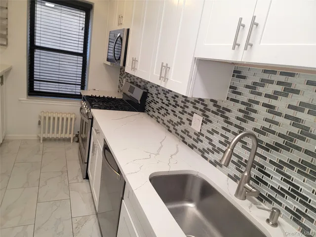 a kitchen with a sink and a stove top oven