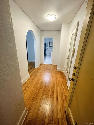 a view of a room with wooden floors and stairs