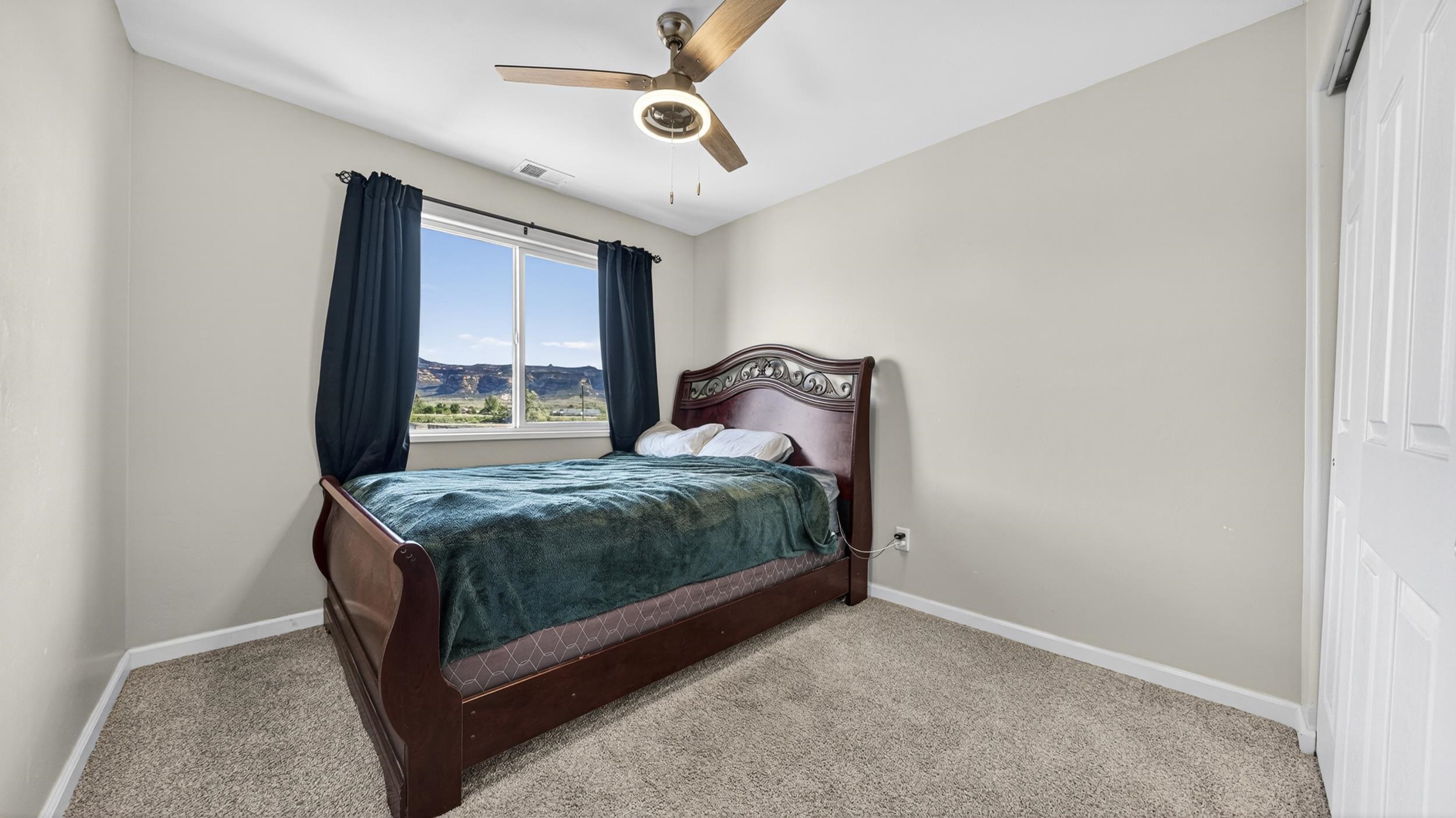 475 David Court Fruita, CO 81521 - Photo 16 of 29 a bedroom with a bed and a window