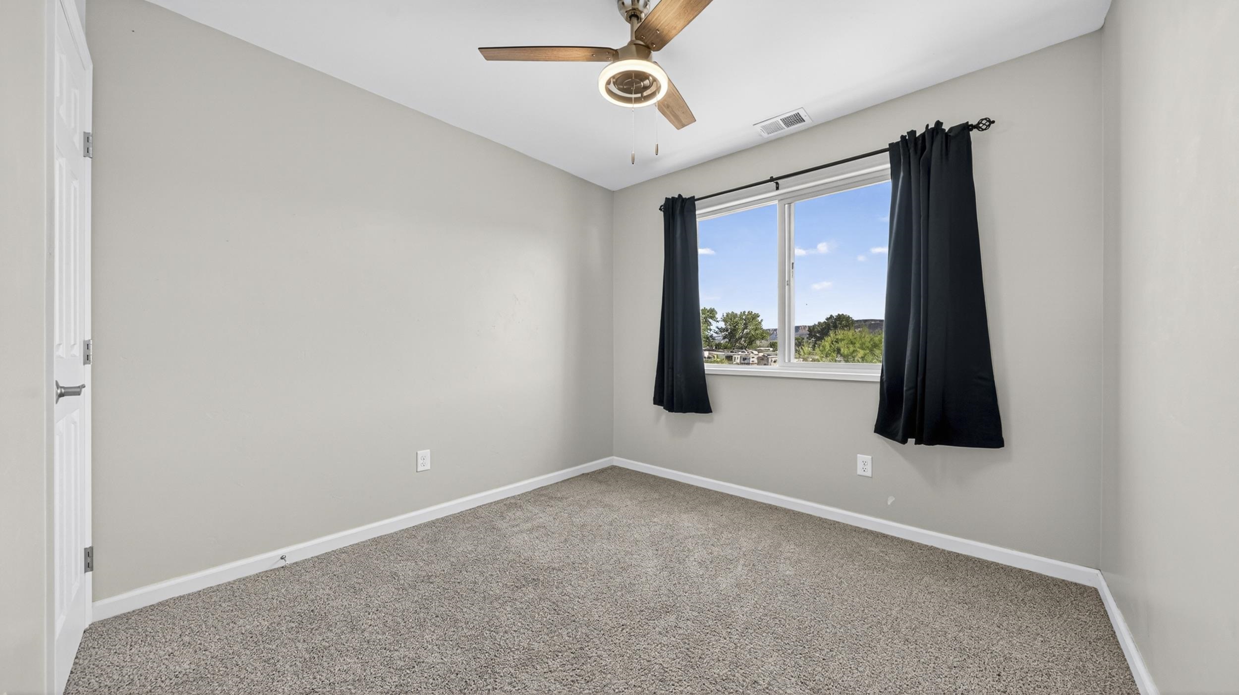 475 David Court Fruita, CO 81521 - Photo 19 of 29 an empty room with windows and fan