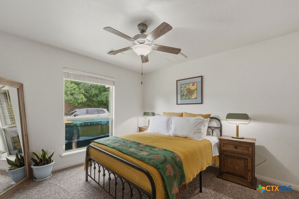 3306 Spring Canyon Road Belton, TX 76513 - Photo 28 of 40 a bedroom with a balcony a bed and a chandelier