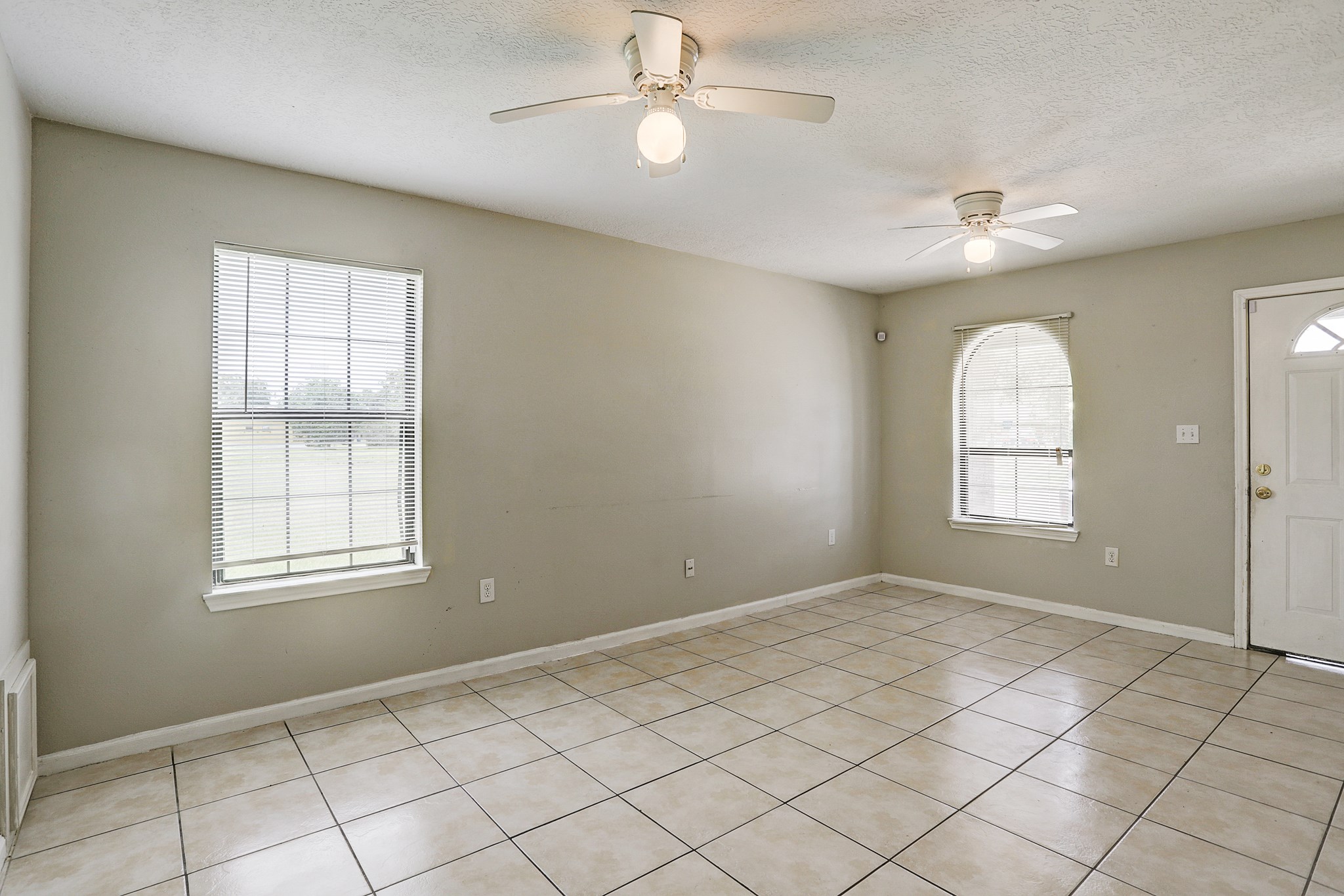 330 6th Street Hempstead, TX 77445 - Photo 3 of 13 wooden floor in an empty room with a window