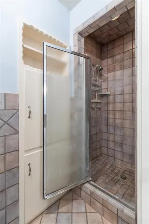 a bathroom with a glass door shower