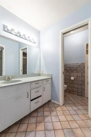 a spacious bathroom with a granite countertop sink mirror and shower