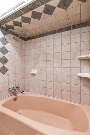 a bathroom with a bathtub and shower
