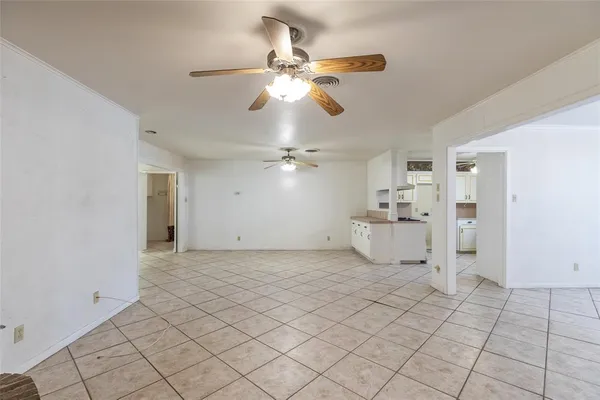 a view of a livingroom with a ceiling fan and window