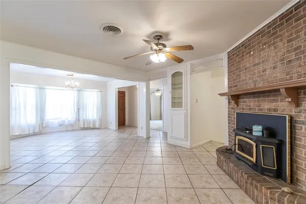 a view of a livingroom with a fireplace and window