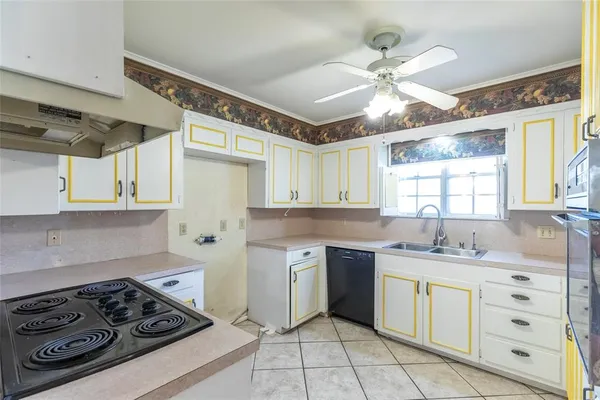 a kitchen with a stove a sink and a window