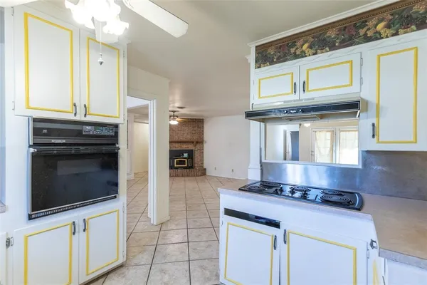 a kitchen with stainless steel appliances granite countertop a stove and a microwave