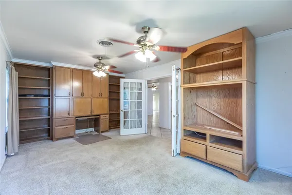 a view of an empty room with a ceiling fan