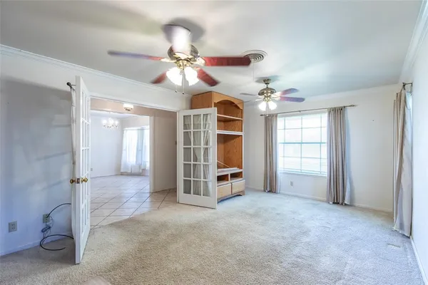 a view of a livingroom with a ceiling fan and window