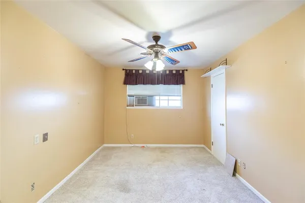 a view of a livingroom with a chandelier fan