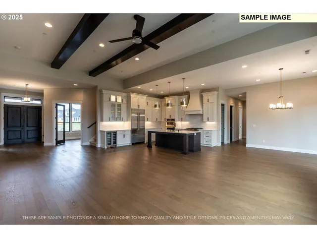 a view of a living room and kitchen with furniture appliances