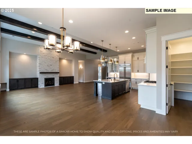 a kitchen with stainless steel appliances kitchen island wooden floors and living room