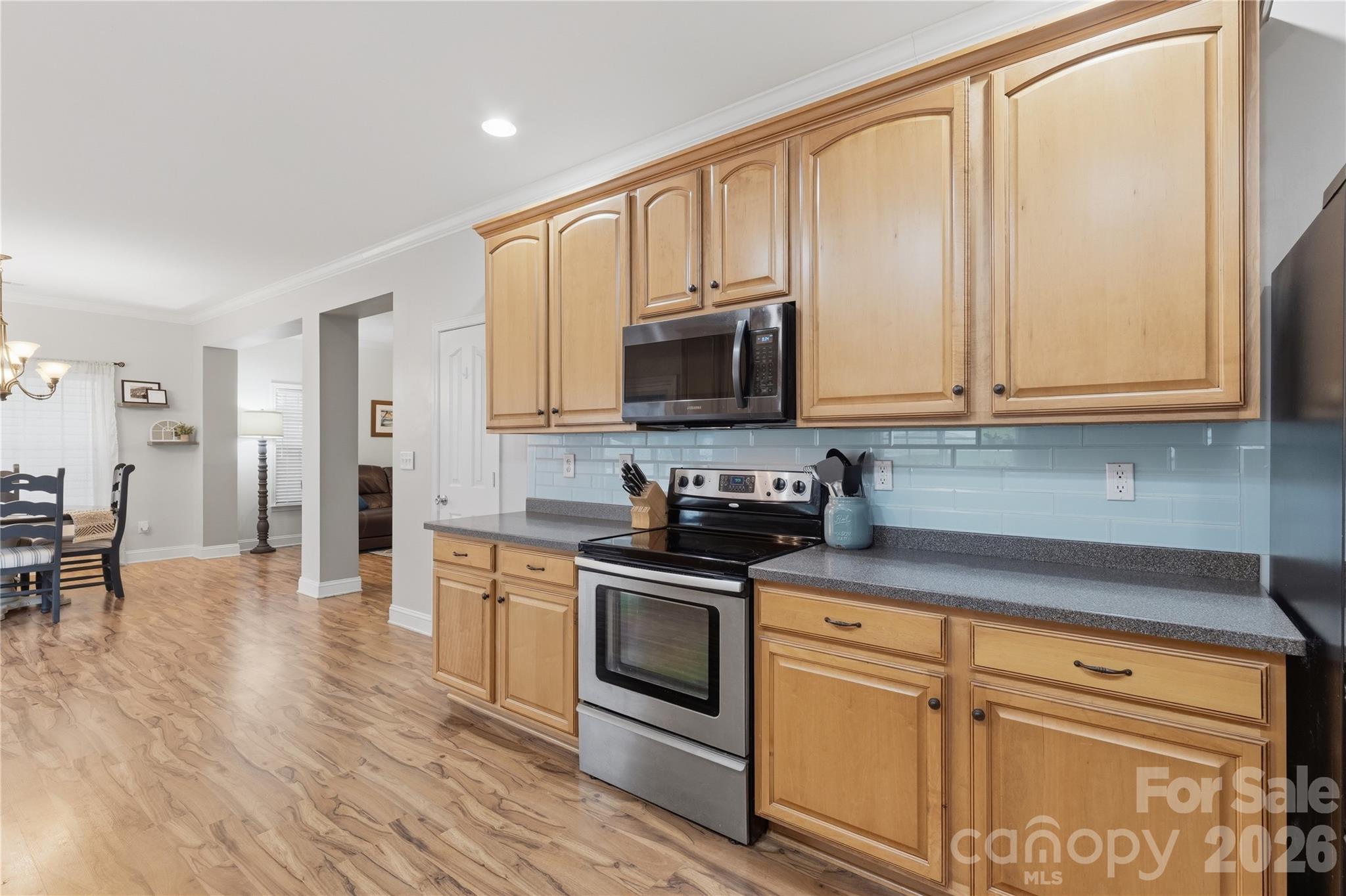 122 Colville Road Mooresville, NC 28117 - Photo 11 of 24 a kitchen with stainless steel appliances granite countertop a stove a sink and a refrigerator