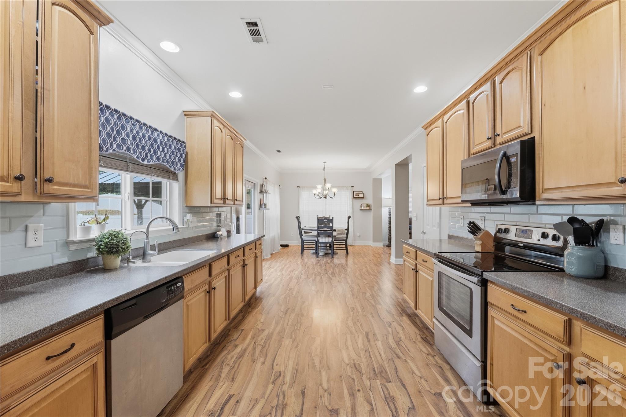 122 Colville Road Mooresville, NC 28117 - Photo 12 of 24 a kitchen with stainless steel appliances granite countertop a sink a stove top oven a counter space and cabinets