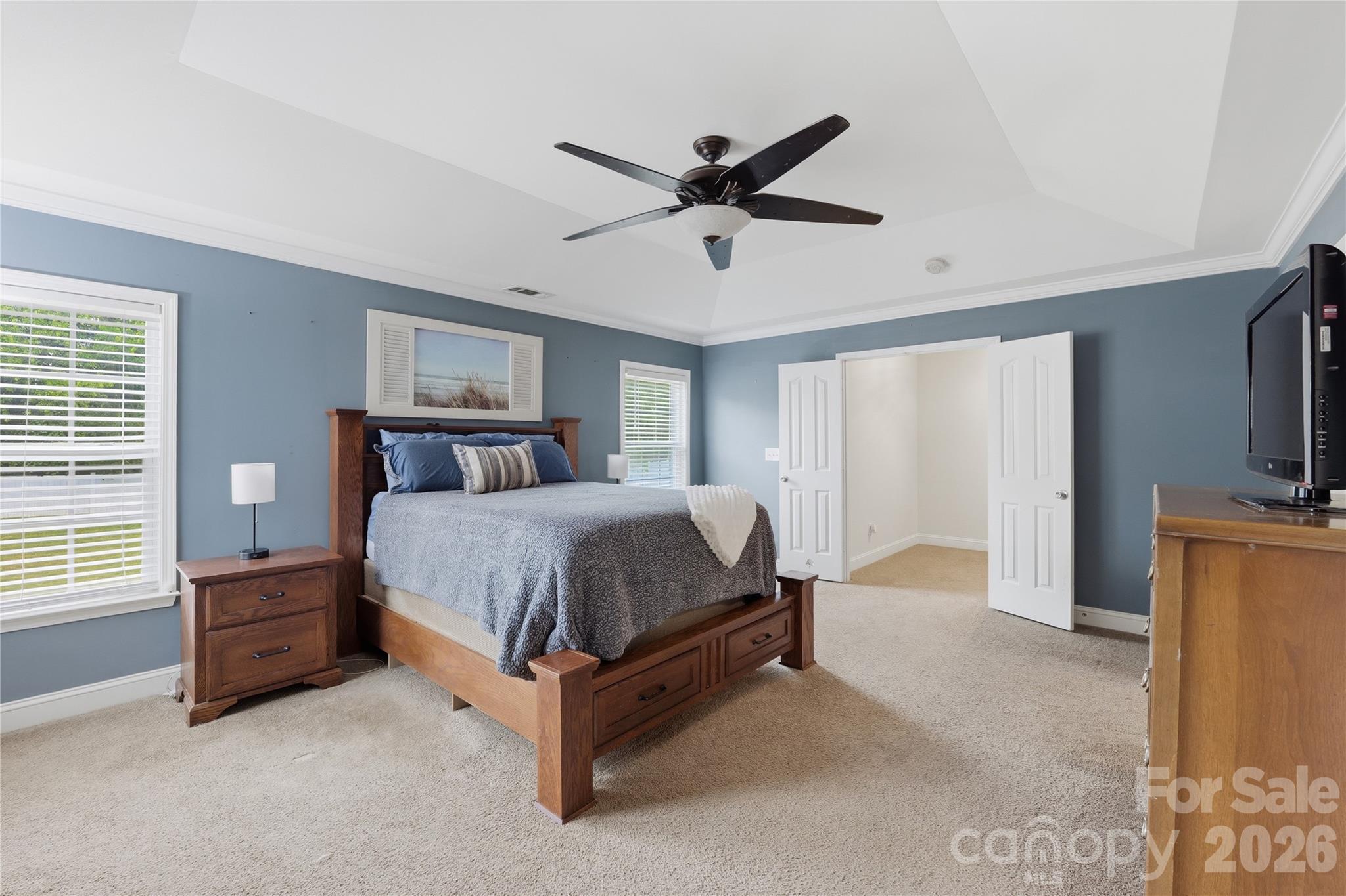 122 Colville Road Mooresville, NC 28117 - Photo 15 of 24 a spacious bedroom with a bed flat screen tv and a window