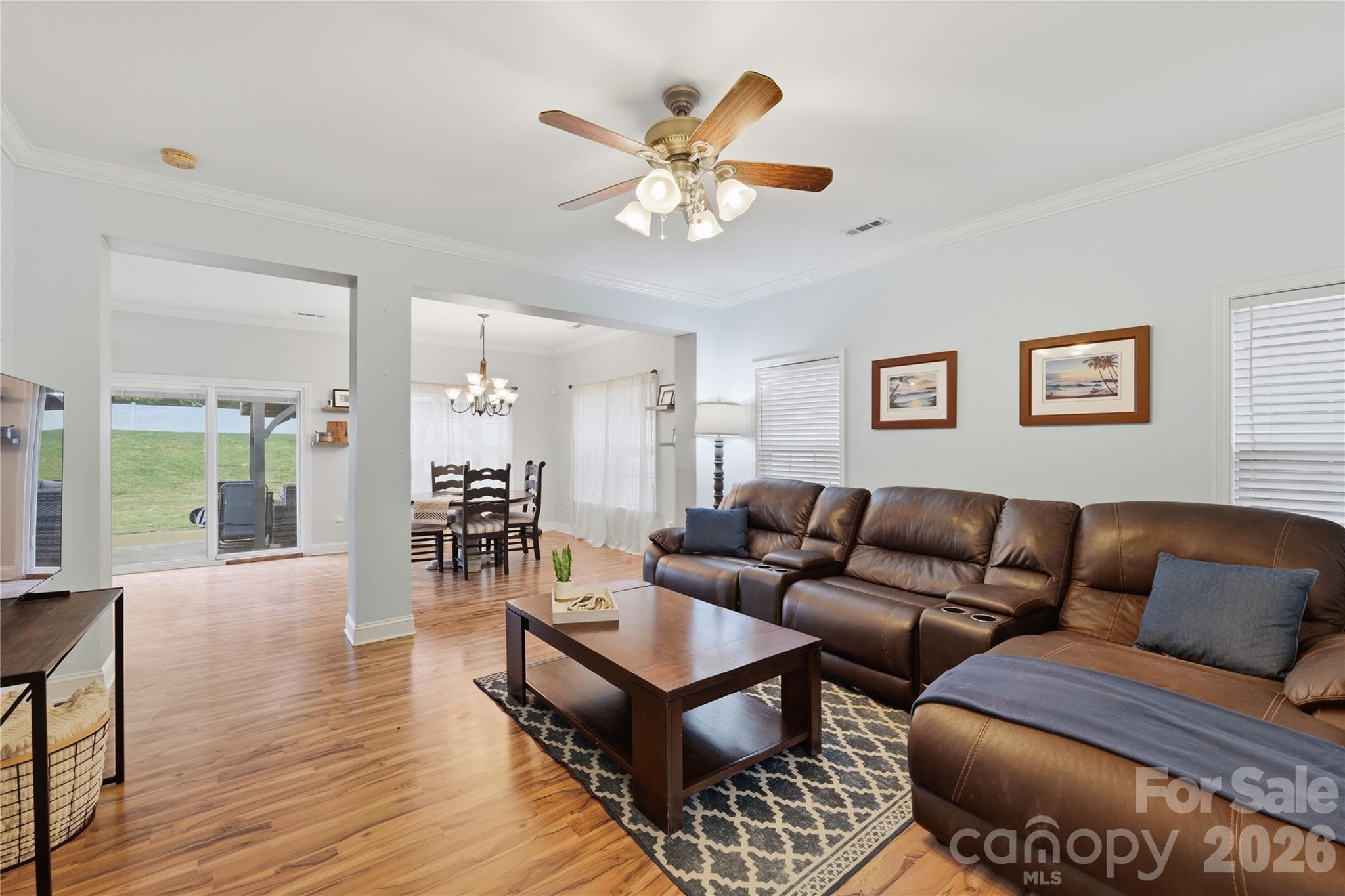 122 Colville Road Mooresville, NC 28117 - Photo 4 of 24 a living room with furniture a wooden floor and a chandelier