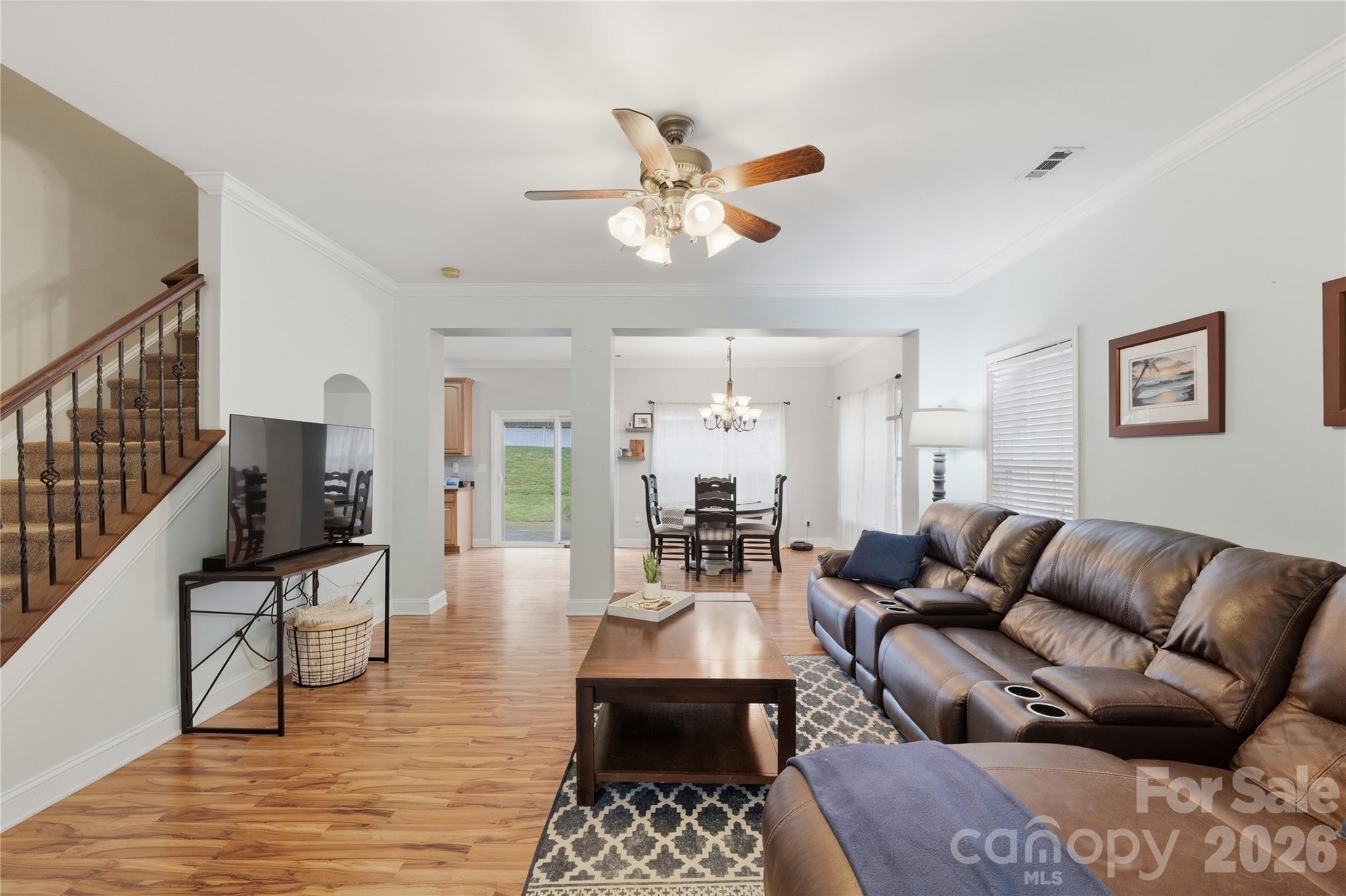 122 Colville Road Mooresville, NC 28117 - Photo 5 of 24 a living room with furniture a rug and a chandelier