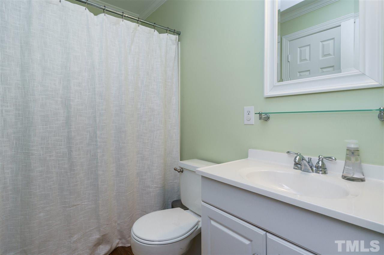 300 Compton Road Raleigh, NC 27609 - Photo 14 of 25 a bathroom with a sink a toilet and a mirror