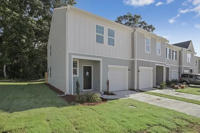 a front view of a house with a yard