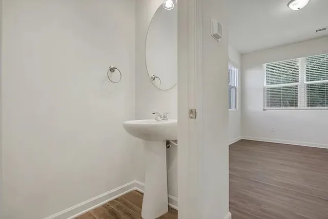 a bathroom with a sink a mirror and shower