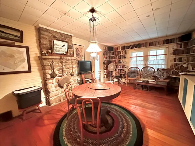 a dining room with furniture a chandelier and wooden floor