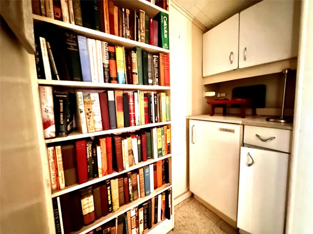 a view of small kitchen with cabinets