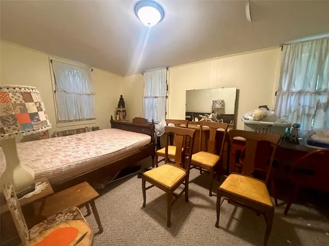 a living room with furniture and a dining table