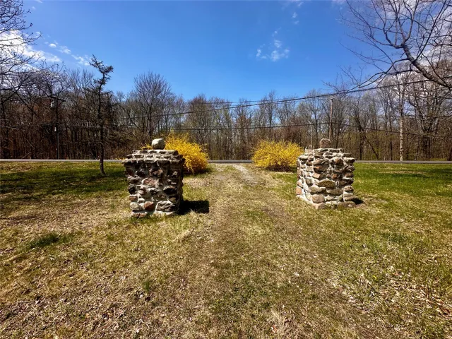 a view of a bench in the patio next to a yard