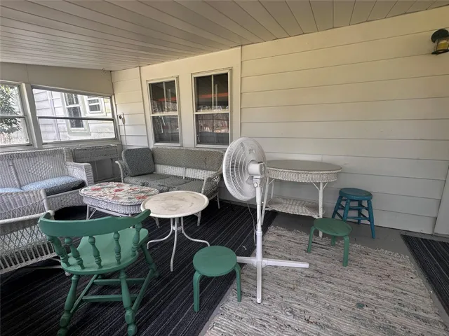 a living room with furniture a window and a table