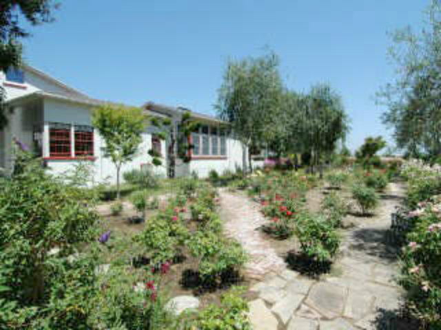 40 Casserly Road Watsonville, CA 95076 - Photo 1 of 1 a view of a garden with a house in the background